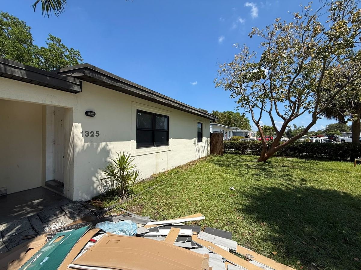 Single-family home with faded, weathered exterior paint before repainting