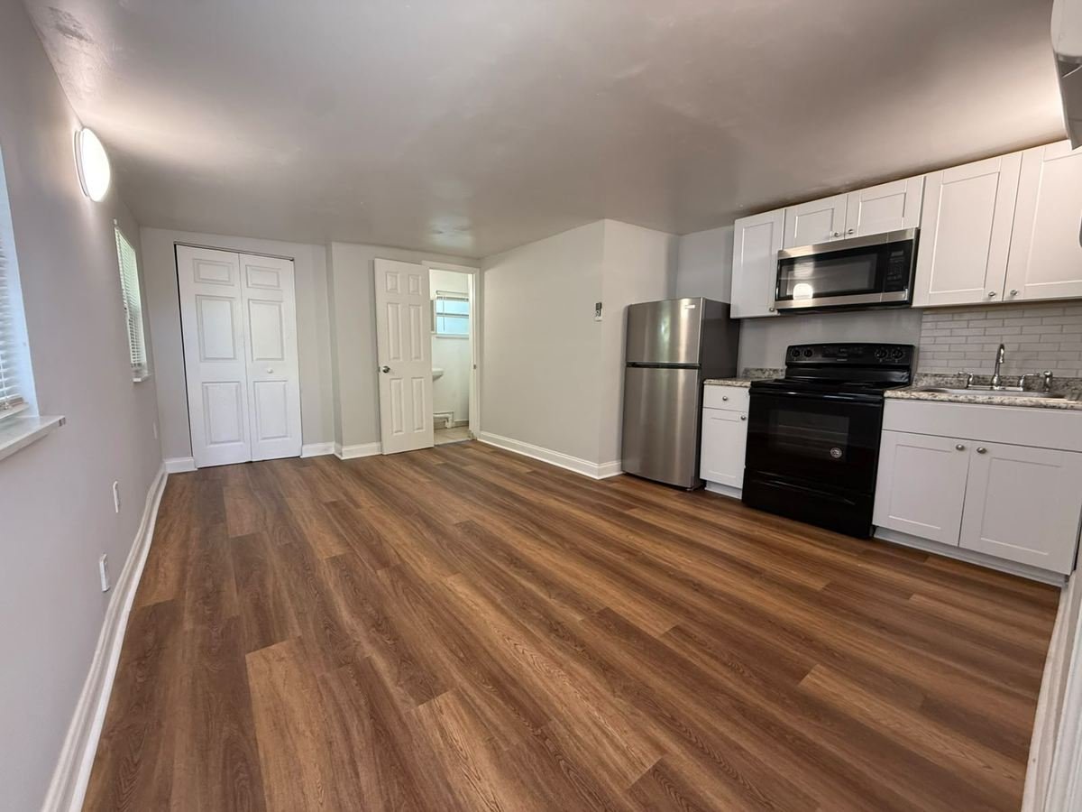 Finished luxury vinyl plank flooring in an open living and kitchen area