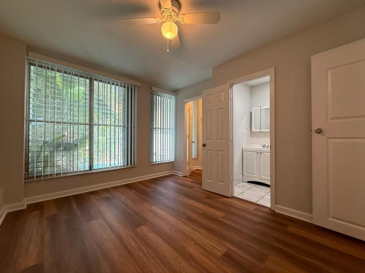 Finished bedroom with vinyl plank flooring and en-suite bathroom
