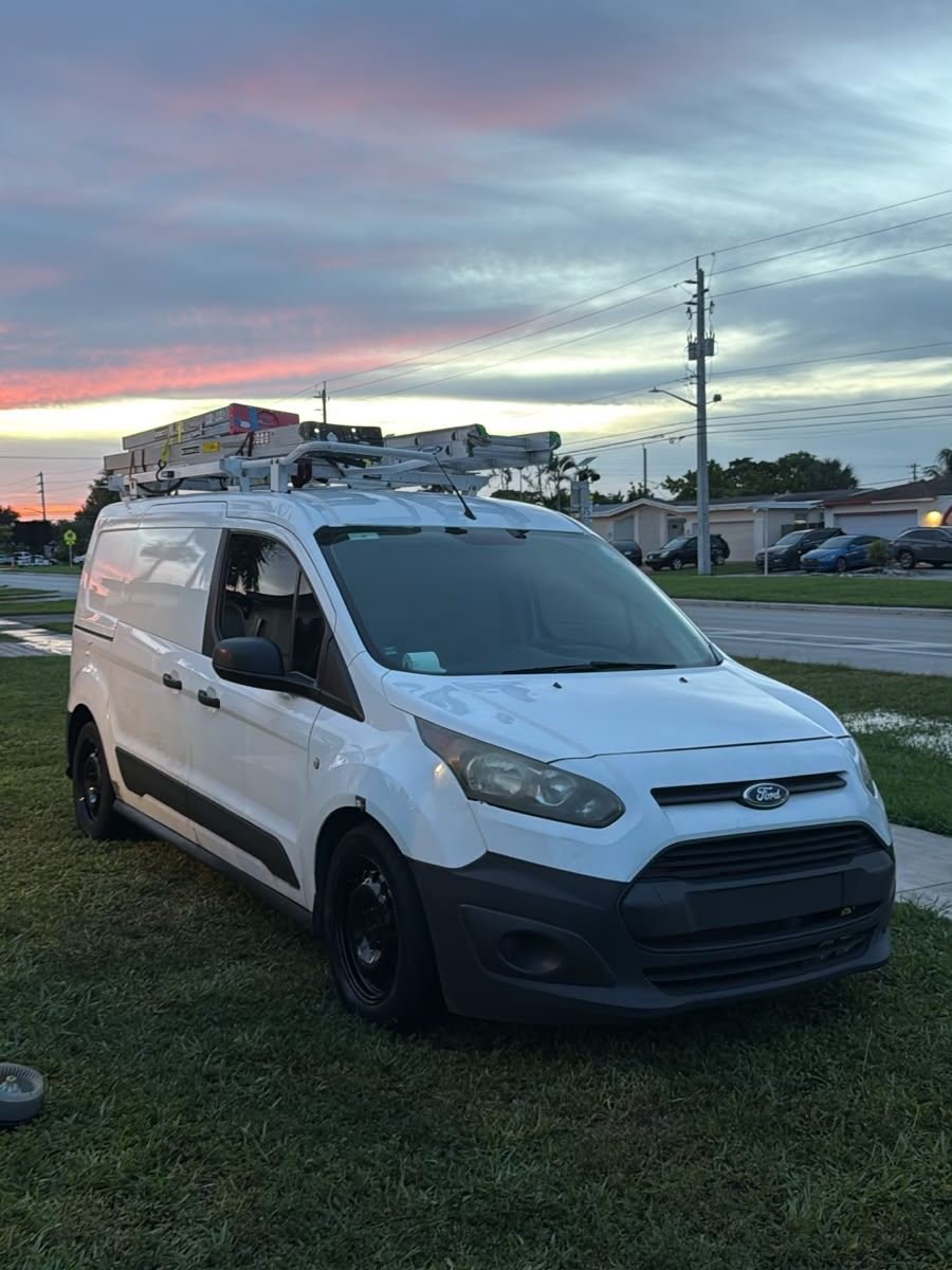 The Luiz Holmes work van loaded with ladders at a South Florida job